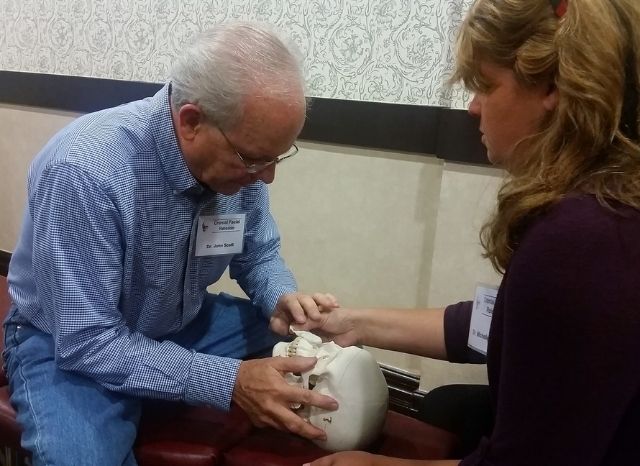 A CFR instructor demonstrating the endonasal balloon instrument at a Cranial Facial Release seminar